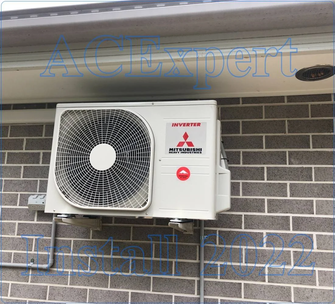 Technician installing a split system to counteract showroom lighting heat in a Melbourne car dealership