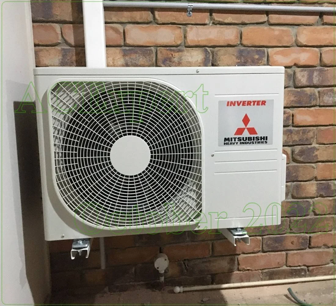 Technician mounting a split system to serve medical practices privacy zones in a Melbourne clinic room