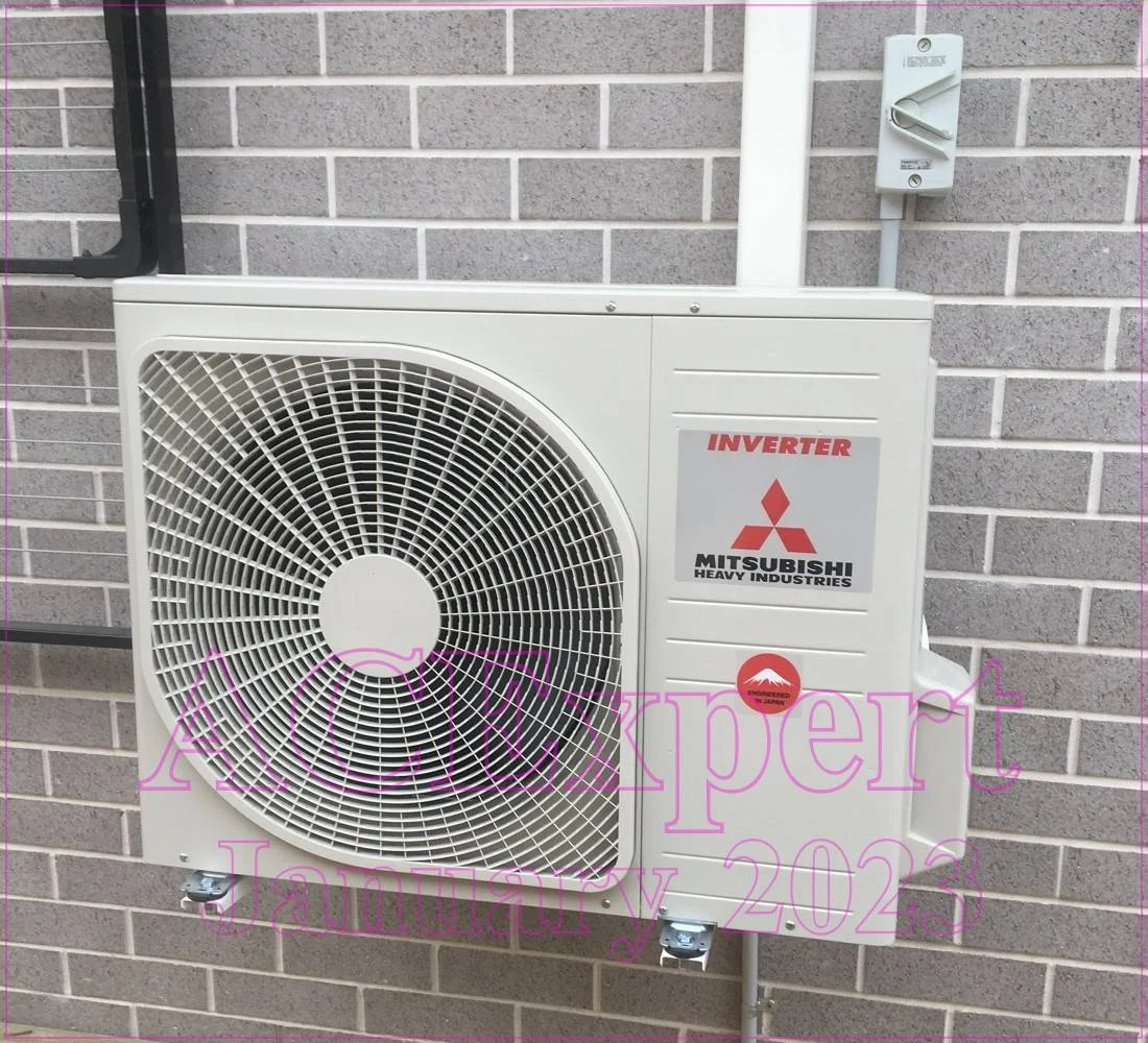 Technician installing a split system air conditioner in a medical facility, ensuring proper ventilation for infection