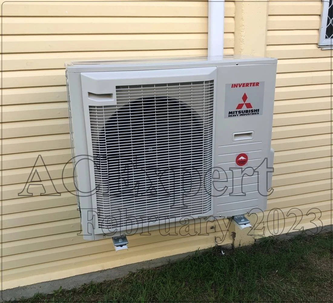 Technician servicing a commercial split system in a Melbourne office building for reliable climate control