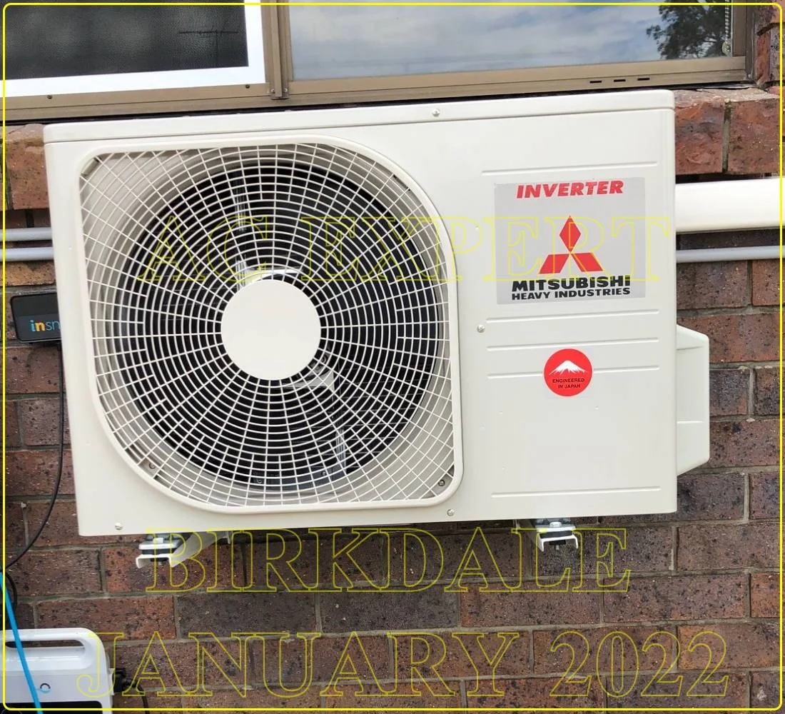 Technician adjusting a split system for landlord-friendly filter access during maintenance in a Melbourne rental.
