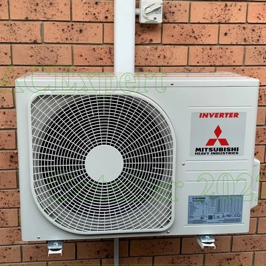 Technician installing a multi-head split system in a modern co-working space, ensuring efficient climate control across