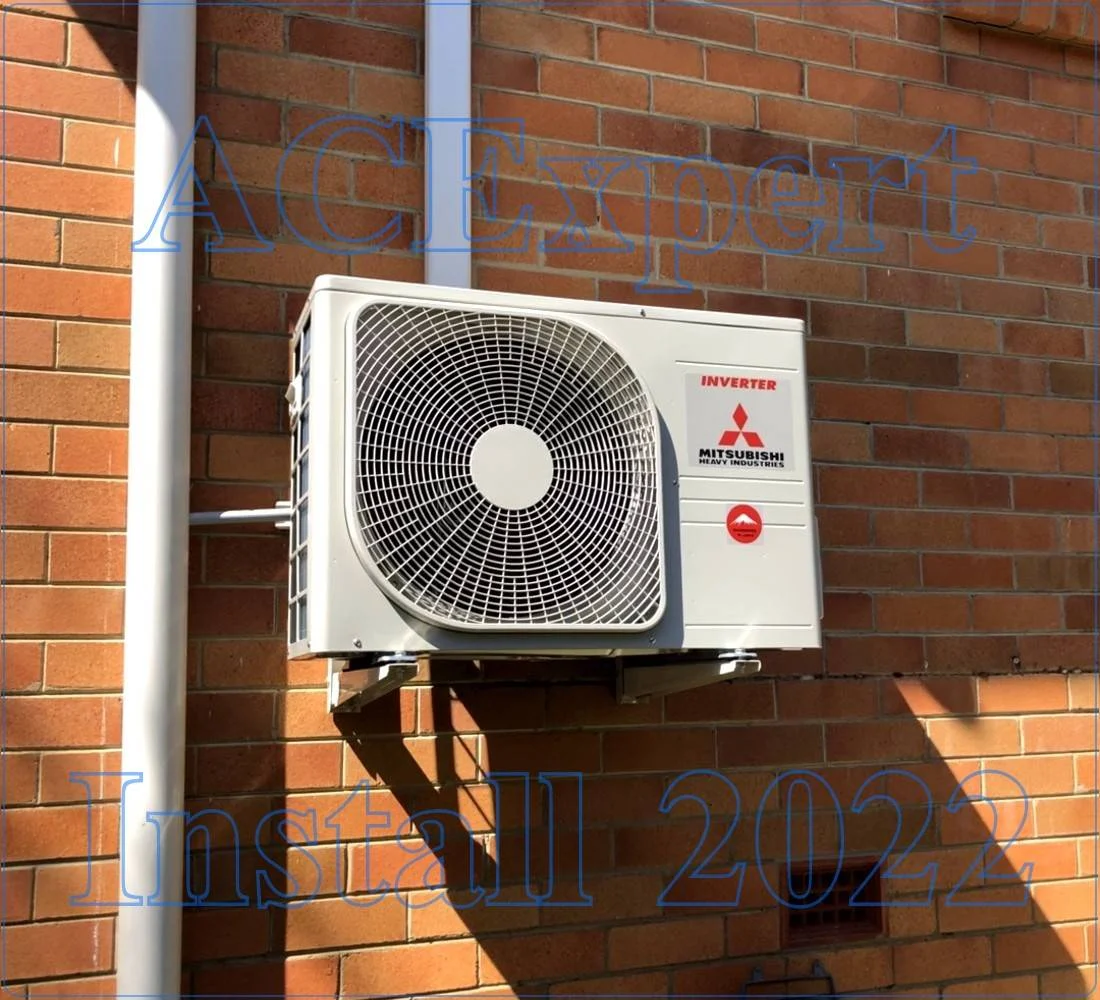 Split System Sizing Installation Example White split system unit on brick wall illustrating split system sizing for builders
